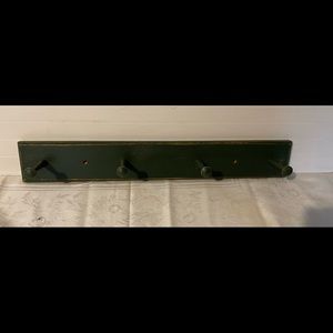 Wooden four peg rack.